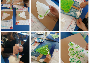 uczniowie wykonują pracę plastyczną przedstawiającą zimowe drzewo