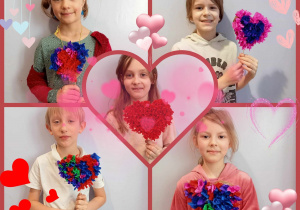 dzieci pozują z wykonanymi przez siebie puchatymi sercami z tektury i bibuły foto 1